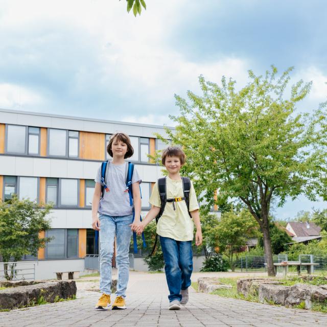 Two children walking at school