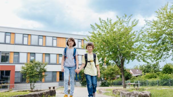 Two children walking at school